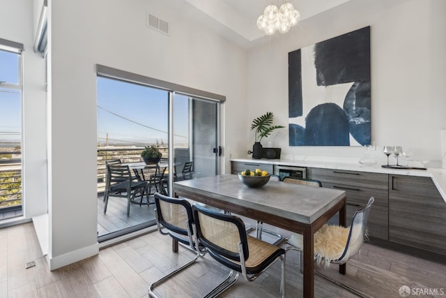 608 Missouri St Unit A, San Francisco, CA 94107 - dining room with a chandelier, a towering ceiling, light wood finished floors, and baseboards