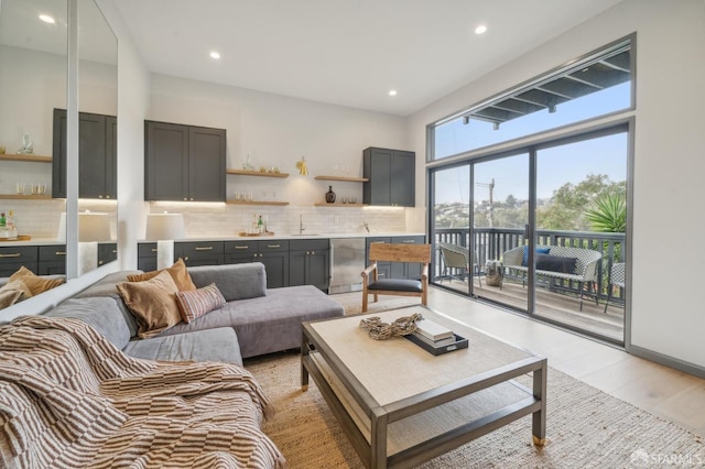 living room featuring sink and light hardwood / wood-style floors