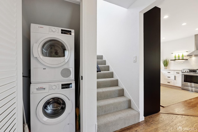 2464 Alida St, Oakland, CA 95602 - laundry room featuring stacked washing machine and dryer, light wood finished floors, and recessed lighting
