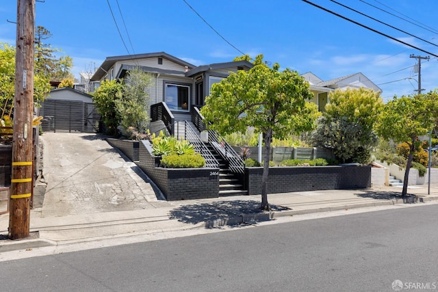 2464 Alida St, Oakland, CA 95602 - view of property hidden behind natural elements featuring an outbuilding and stairs