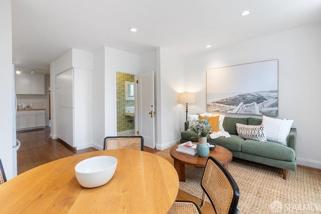 living room featuring recessed lighting, baseboards, and wood finished floors