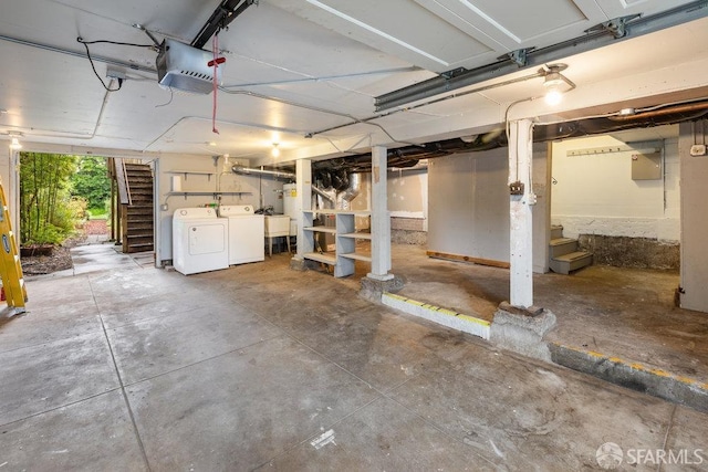 garage featuring a garage door opener and independent washer and dryer