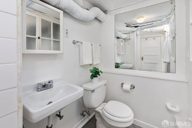 half bathroom featuring a sink and toilet