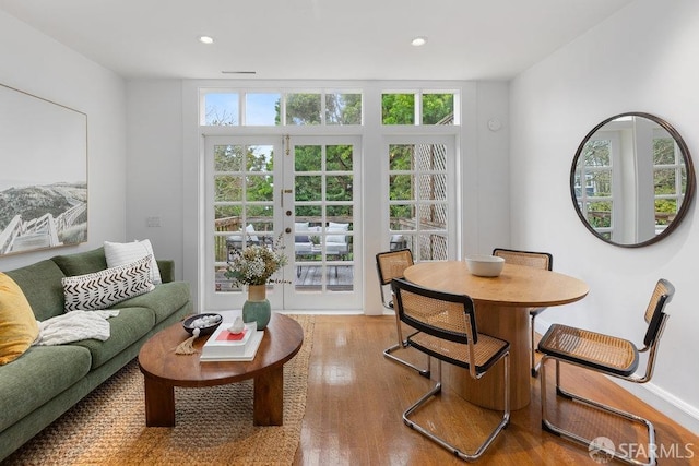 living area featuring french doors, recessed lighting, plenty of natural light, and light wood-style floors