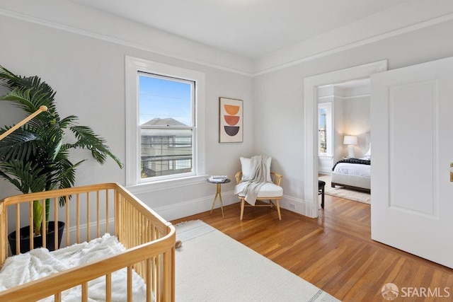 bedroom featuring baseboards and wood finished floors