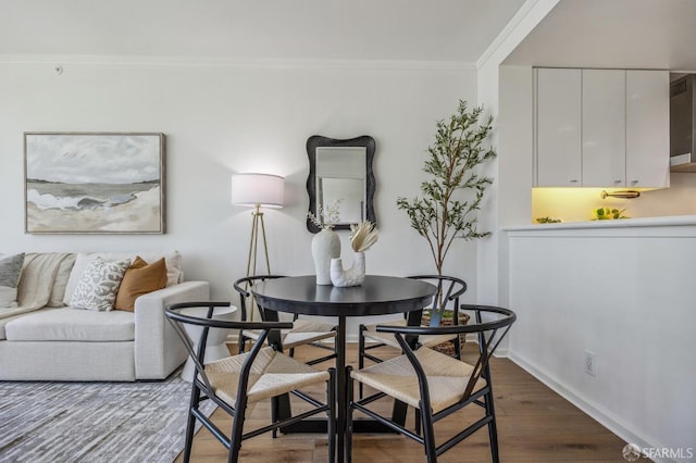 dining room featuring dark hardwood / wood-style flooring and ornamental molding