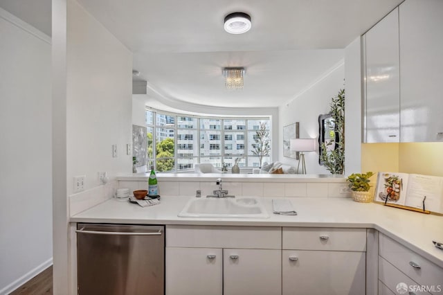 kitchen with dark wood-type flooring, sink, white cabinetry, and dishwasher