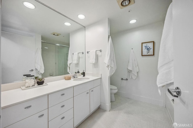 bathroom with toilet, tile patterned flooring, an enclosed shower, and vanity