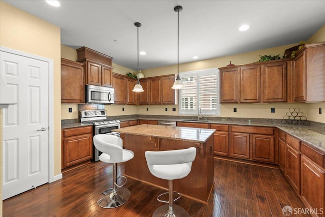 41008 Asilomar Ter, Fremont, CA 94538 - kitchen with stainless steel appliances, brown cabinets, dark wood-style flooring, and recessed lighting