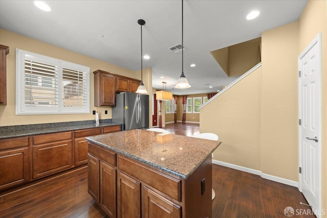 41008 Asilomar Ter, Fremont, CA 94538 - kitchen featuring freestanding refrigerator, a center island, brown cabinets, dark wood finished floors, and recessed lighting