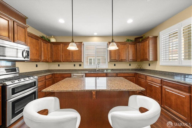 41008 Asilomar Ter, Fremont, CA 94538 - kitchen with stainless steel appliances, healthy amount of natural light, a kitchen island, a kitchen bar, and recessed lighting
