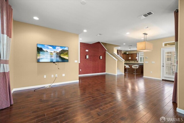 41008 Asilomar Ter, Fremont, CA 94538 - unfurnished living room with dark wood-style floors, baseboards, recessed lighting, and stairs