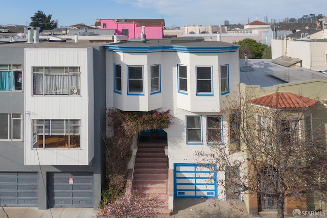 view of front of house with stairway and an attached garage