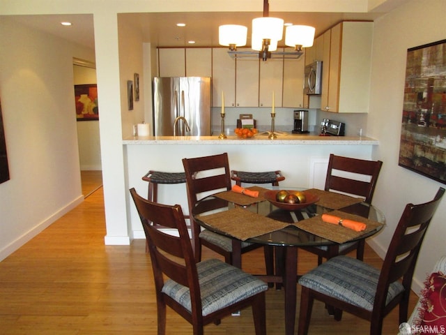 601 Van Ness Ave Unit 1102, San Francisco, CA 94102 - dining room with light wood-type flooring and a chandelier