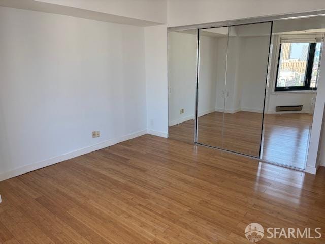 601 Van Ness Ave Unit 1102, San Francisco, CA 94102 - unfurnished bedroom with wood finished floors and a closet