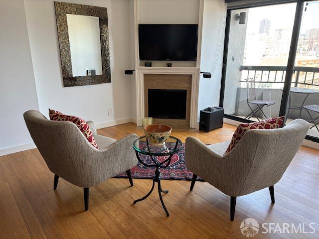 601 Van Ness Ave Unit 1102, San Francisco, CA 94102 - living room featuring wood finished floors and a fireplace with flush hearth
