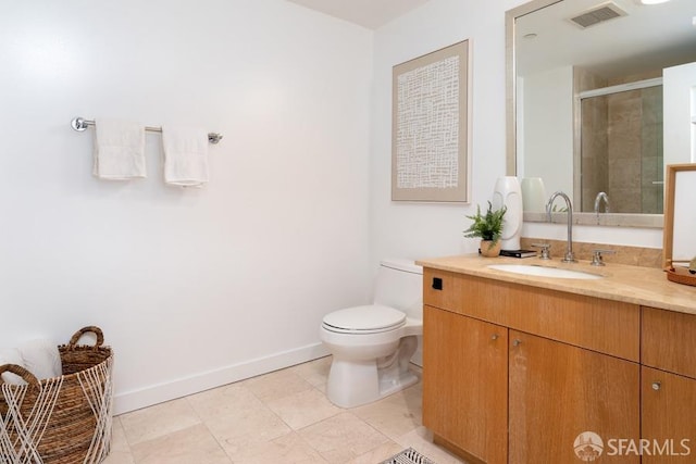 bathroom with tile patterned floors, vanity, toilet, and an enclosed shower