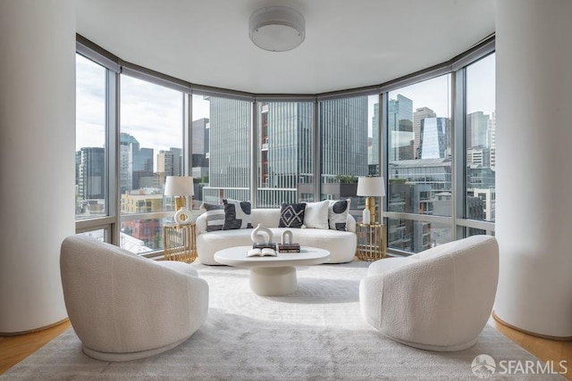 living room featuring hardwood / wood-style floors and a wall of windows