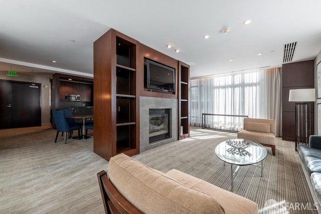 carpeted living room featuring a fireplace