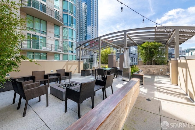 view of patio with a pergola and a balcony