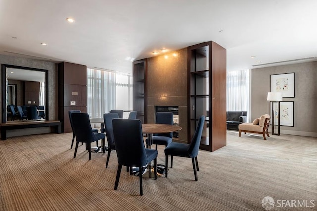 carpeted dining room featuring a fireplace