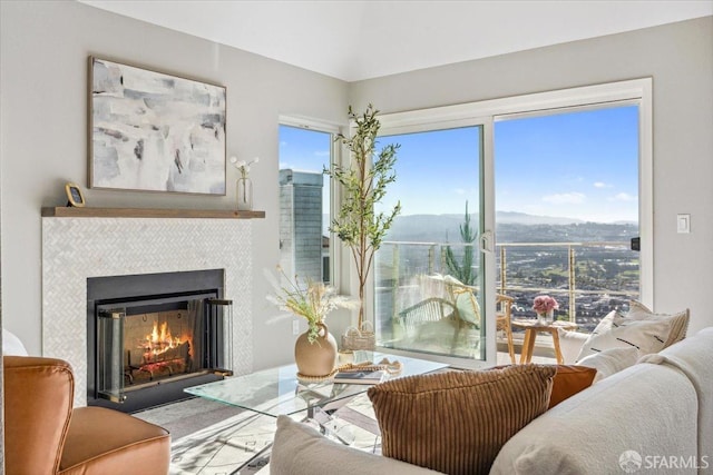 living room with a tiled fireplace