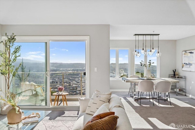 carpeted dining room with a mountain view and an inviting chandelier