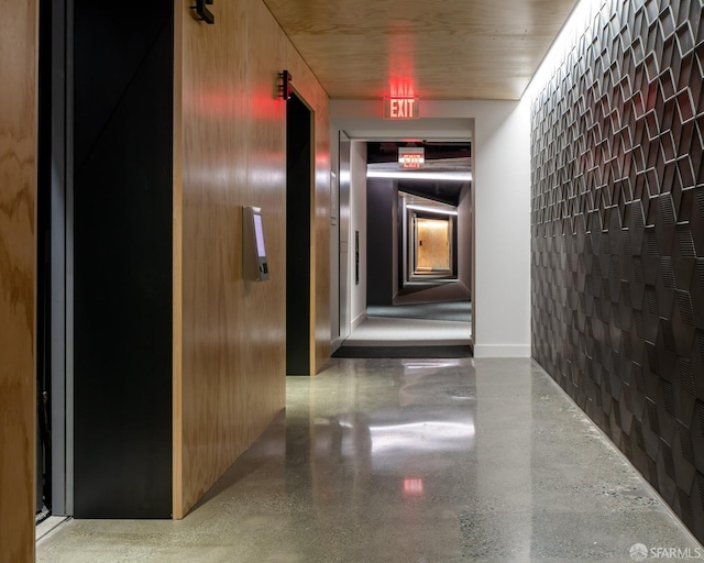 hall featuring concrete block wall