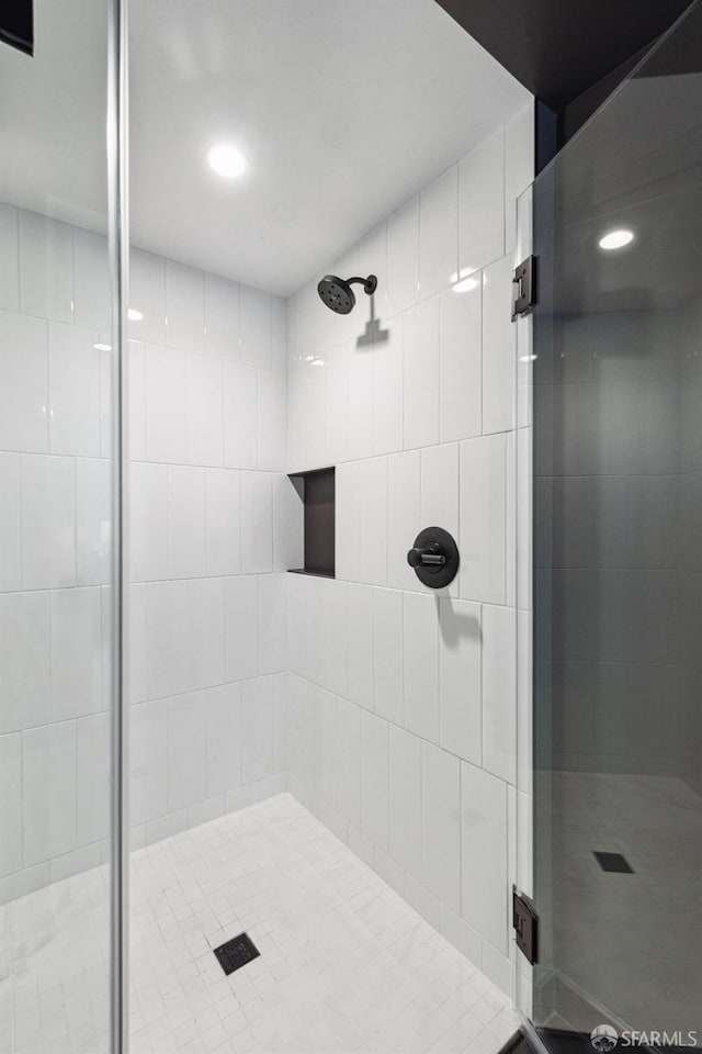 bathroom with a stall shower and recessed lighting