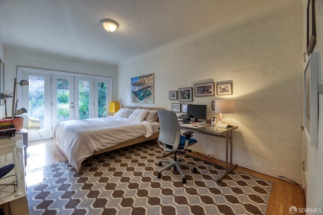 bedroom featuring hardwood / wood-style flooring, access to exterior, and french doors