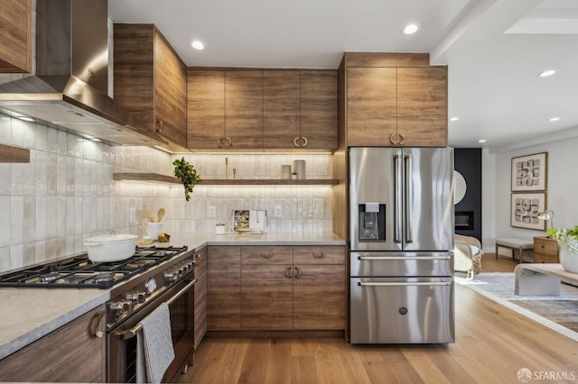 57 Niagara Ave, San Francisco, CA 94112 - kitchen featuring stainless steel appliances, wall chimney exhaust hood, backsplash, wood finished floors, and recessed lighting