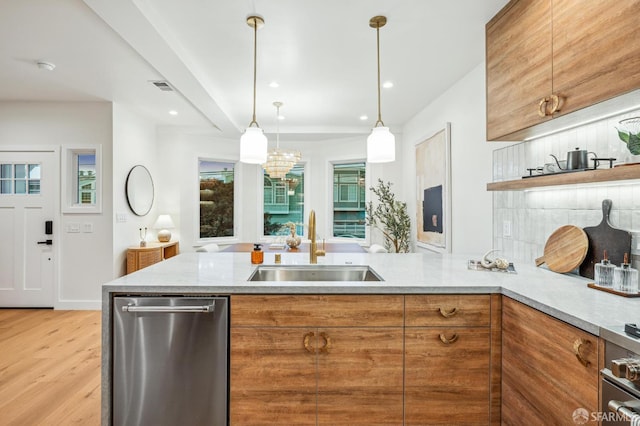 57 Niagara Ave, San Francisco, CA 94112 - kitchen featuring dishwasher, brown cabinetry, light wood-style floors, light stone countertops, and a peninsula