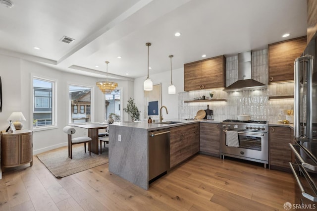 57 Niagara Ave, San Francisco, CA 94112 - kitchen featuring high quality appliances, wall chimney exhaust hood, brown cabinets, decorative backsplash, and modern cabinets