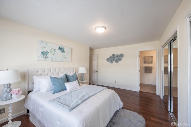 bedroom featuring dark wood-style floors and baseboards