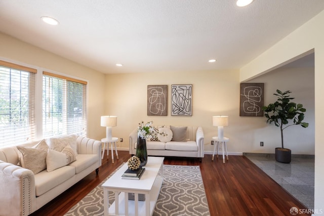 living area with recessed lighting, dark wood-type flooring, and baseboards