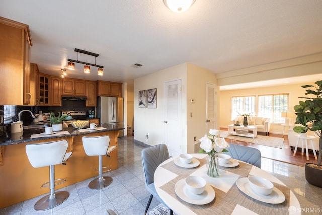 dining room with granite finish floor, visible vents, and baseboards