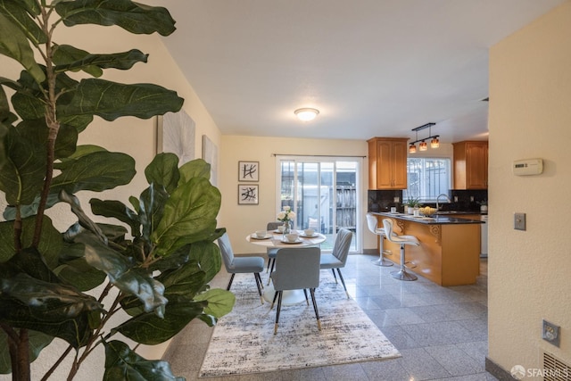 dining space featuring baseboards and granite finish floor