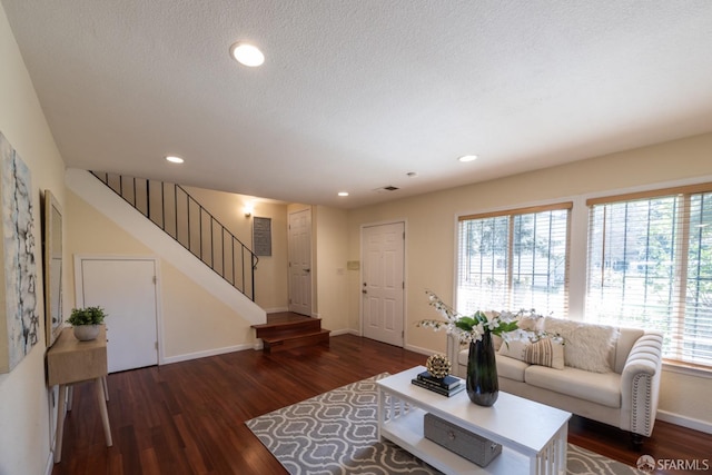 living area featuring stairway, dark wood-style floors, baseboards, recessed lighting, and a textured ceiling