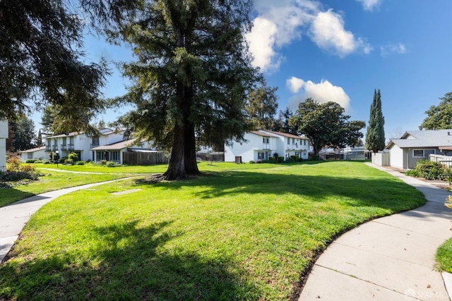 view of yard featuring fence and a residential view