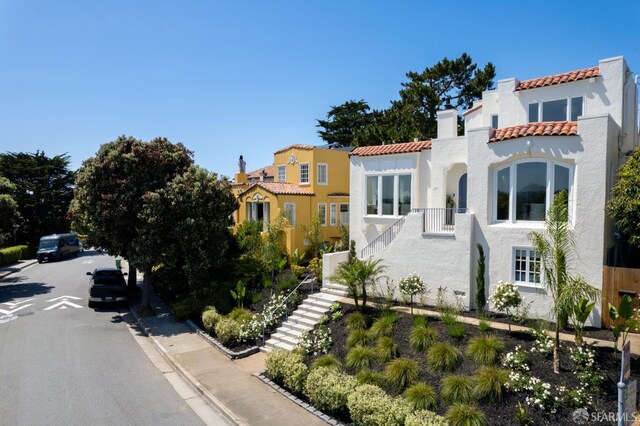 130 Cerritos Ave, San Francisco, CA 94127 - mediterranean / spanish-style home with a chimney, a tile roof, stairway, and stucco siding