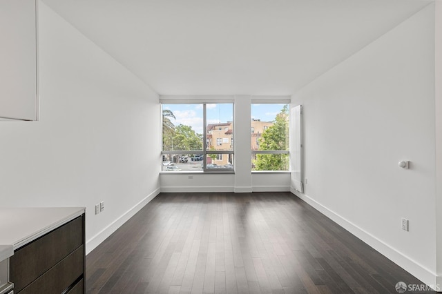 8 Buchanan St Unit 202, San Francisco, CA 94102 - unfurnished room featuring baseboards and dark wood-style flooring