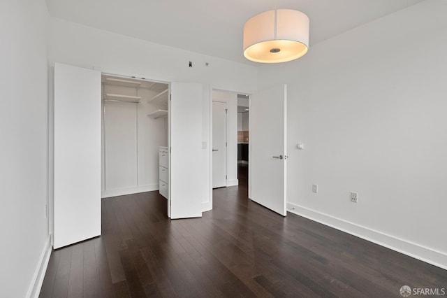 8 Buchanan St Unit 202, San Francisco, CA 94102 - unfurnished bedroom with dark wood-type flooring, baseboards, and a closet