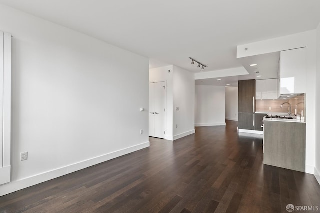 8 Buchanan St Unit 202, San Francisco, CA 94102 - unfurnished living room with dark wood-type flooring, recessed lighting, a sink, and baseboards