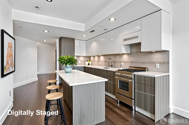 8 Buchanan St Unit 202, San Francisco, CA 94102 - kitchen featuring modern cabinets, stainless steel range, a breakfast bar, white cabinets, and a center island