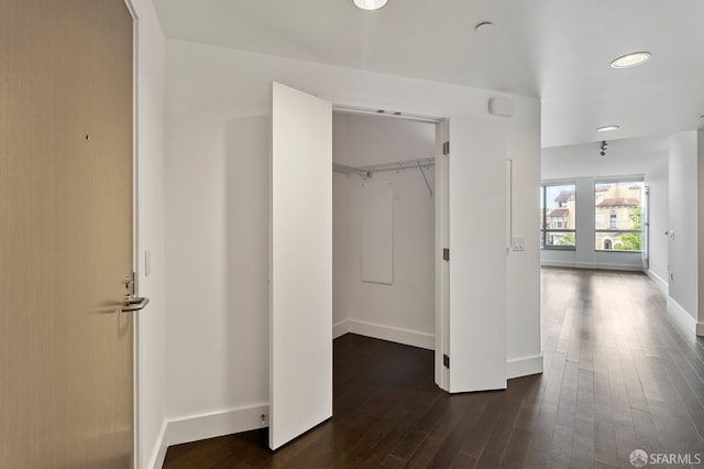 8 Buchanan St Unit 202, San Francisco, CA 94102 - unfurnished bedroom with dark wood finished floors, a spacious closet, a closet, baseboards, and recessed lighting