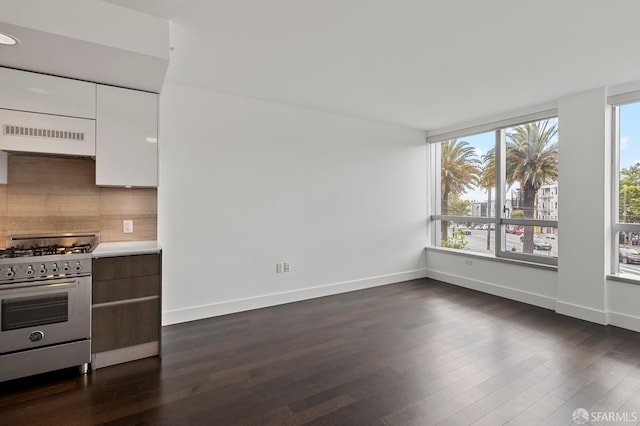 8 Buchanan St Unit 202, San Francisco, CA 94102 - kitchen featuring stainless steel range with gas cooktop, backsplash, dark wood finished floors, light countertops, and white cabinets