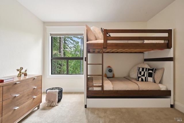 bedroom featuring baseboards and carpet