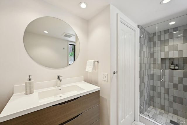 bathroom featuring recessed lighting, visible vents, a shower stall, and vanity