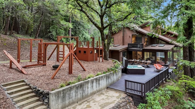 view of playground with a wooden deck