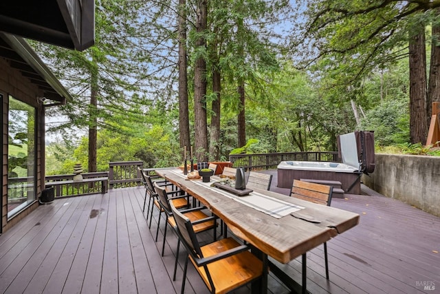 wooden terrace featuring outdoor dining area and a hot tub